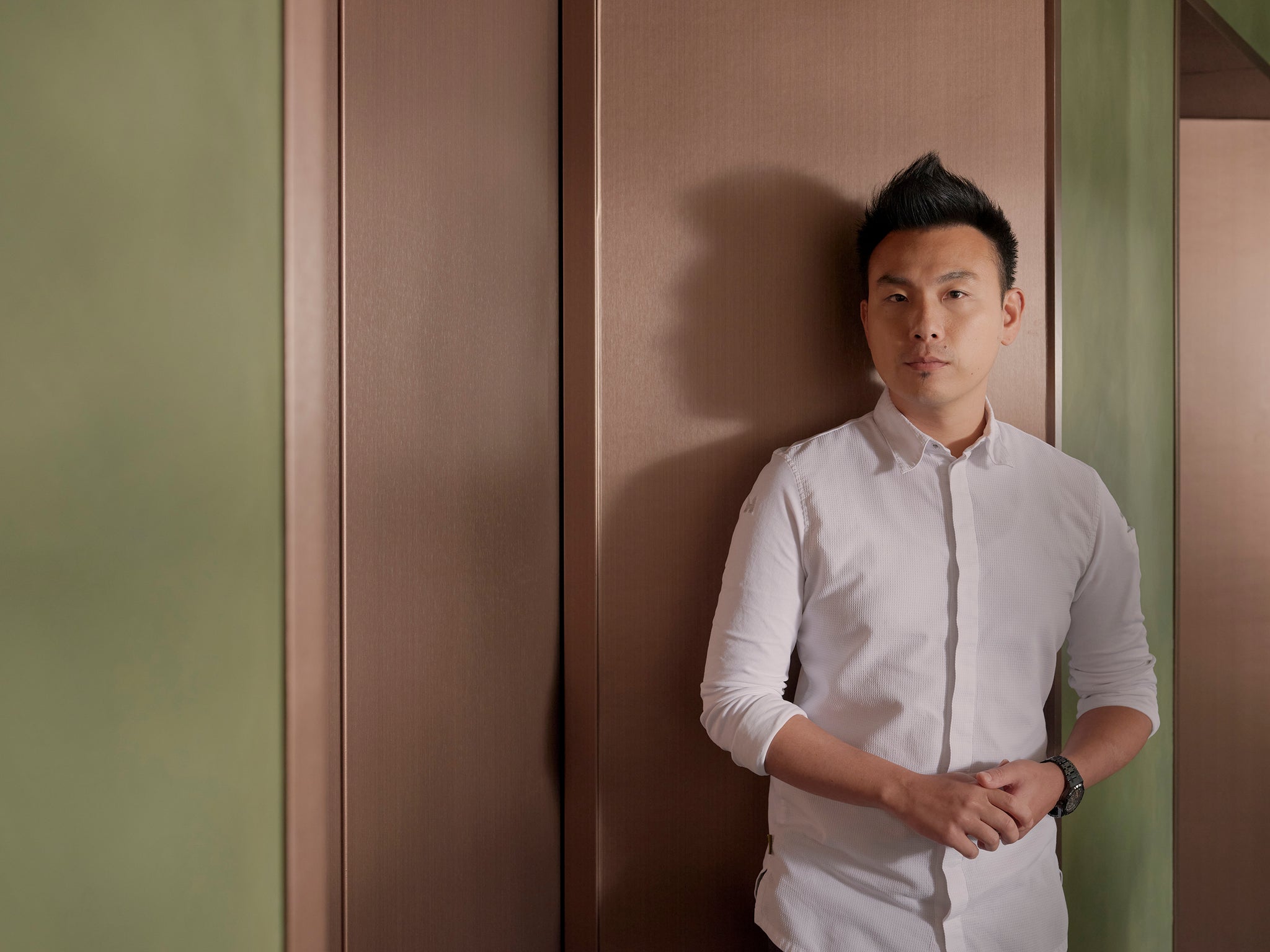 Vicky Cheng, chef and owner of WING restaurant, wearing a white button down shirt against a light pink and green background, interview with a Collected Man London